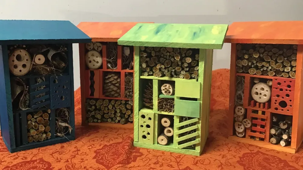 Colourful handcrafted insect hotels in the shop at sensory and play garden Axmar Yara